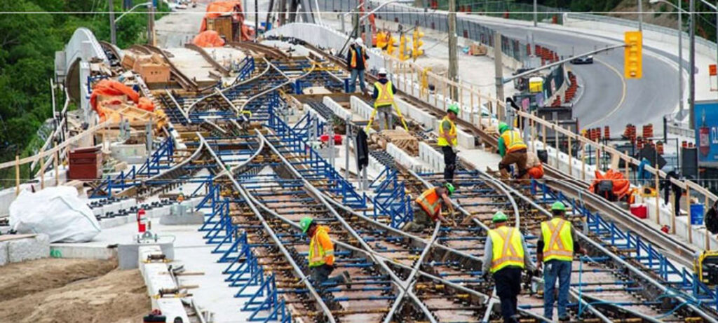 A group of people working on train tracks.